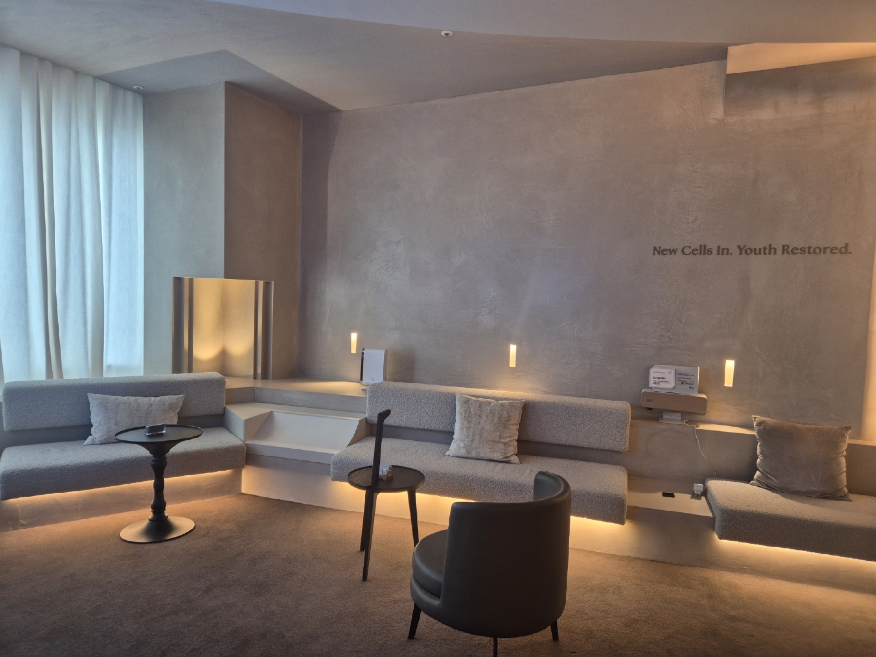 Lounge with 'New Cells In. Youth Restored.' brand wall at Nucellin Orthopedic Clinic in Seoul